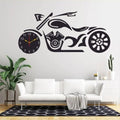 Wall clock designed like a motorcycle on a wall above a white sofa.