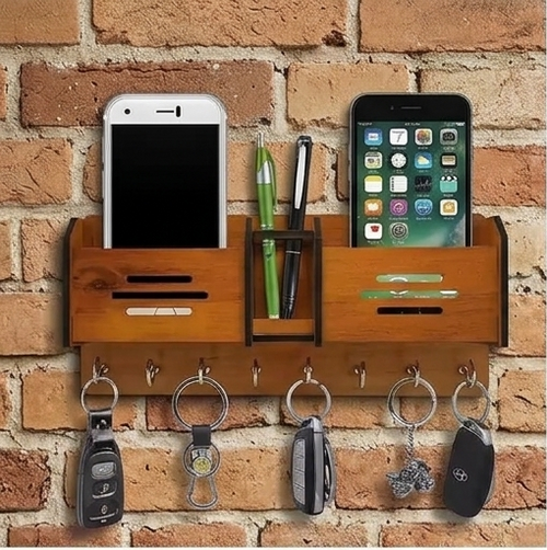 Wall-mounted organizer with phone stands, pen holder, and key hooks against a brick wall.