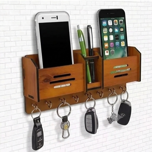 Wooden wall organizer with phone stands, key hooks, and pen holder on a white tiled wall.