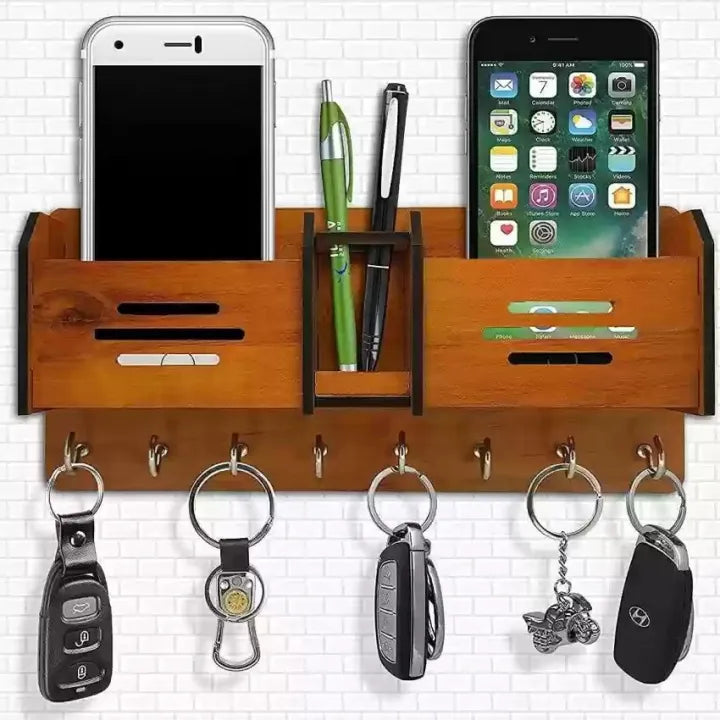Wooden wall organizer with phone stands, pen holder, and key hooks on a white tiled wall.