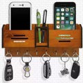 Wooden wall organizer with phone stands, pen holder, and key hooks on a white tiled wall.