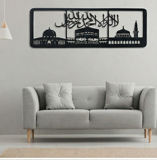 Gray sofa with decorative pillows against a wall with a black and white wall art piece.