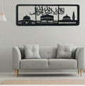 Gray sofa with decorative pillows against a wall with a black and white wall art piece.