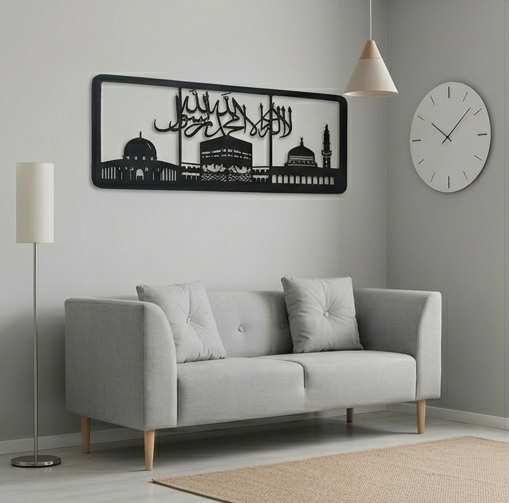 Gray sofa in a living room with a decorative wall art piece and clock.