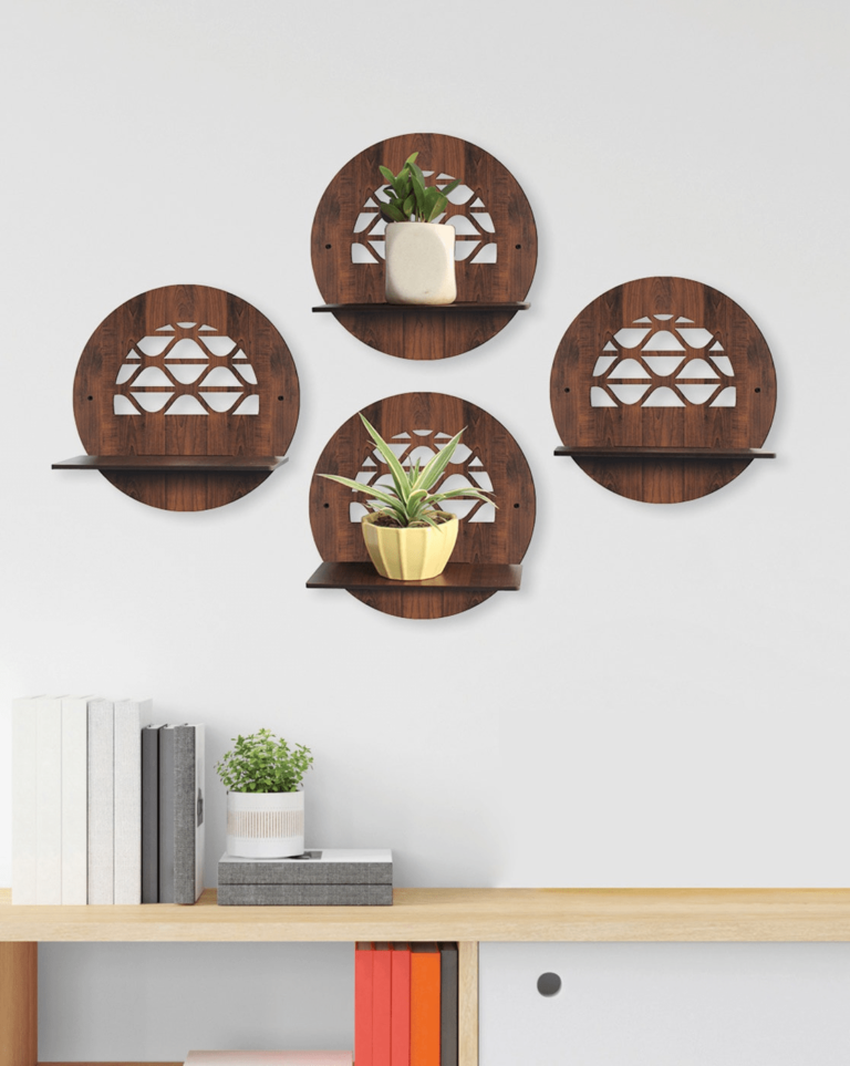 Set of four wooden wall shelves with decorative cut-out designs, each holding a small plant or pot on a white wall.